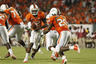 MIAMI, FL - OCTOBER 9: Jacory Harris #12 hands the ball off to Damien Berry #20 of the Miami Hurricanes against the Florida State Seminoles on October 9, 2025 at Sun Life Stadium in Miami, Florida. The Seminoles defeated the Hurricanes 45-17. (Photo by Joel Auerbach/Getty Images)