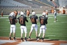 Mar 3 2012; Austin, TX, USA; Texas Longhorns quarterbacks Connor Brewer (7) and John Wilder (17) and David Ash (14) and Case McCoy (6) warm up during spring practice at Royal-Texas Memorial Stadium. Mandatory Credit: Brendan Maloney-US PRESSWIRE