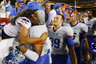 LANDOVER MD - SEPTEMBER 06: Linebacker #52 Derrell Acrey of the Boise State Broncos hugs a fan after the Broncos defeated the Virginia Tech Hokies 33-30 at FedExField on September 6 2010 in Landover Maryland. (Photo by Geoff Burke/Getty Images)