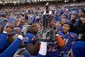 Boise State's Will Lawrence (59) helps his teammates hold up the Western Athletic Conference (WAC) championship trophy after defeating Utah State during an NCAA college football game, Saturday, Dec. 4, 2010, in Boise, Idaho. No. 9 Boise State won 50-14. (AP Photo/Matt Cilley)