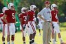 Stanford head coach Jim Harbaugh, second from right, blows a bubble as he watches his team practice at Barry University in Miami Shores, Fla., Wednesday, Dec. 29, 2010. Stanford is scheduled to play Virginia Tech in the Orange Bowl NCAA college football game on Jan. 3, 2010. (AP Photo/Hans Deryk)